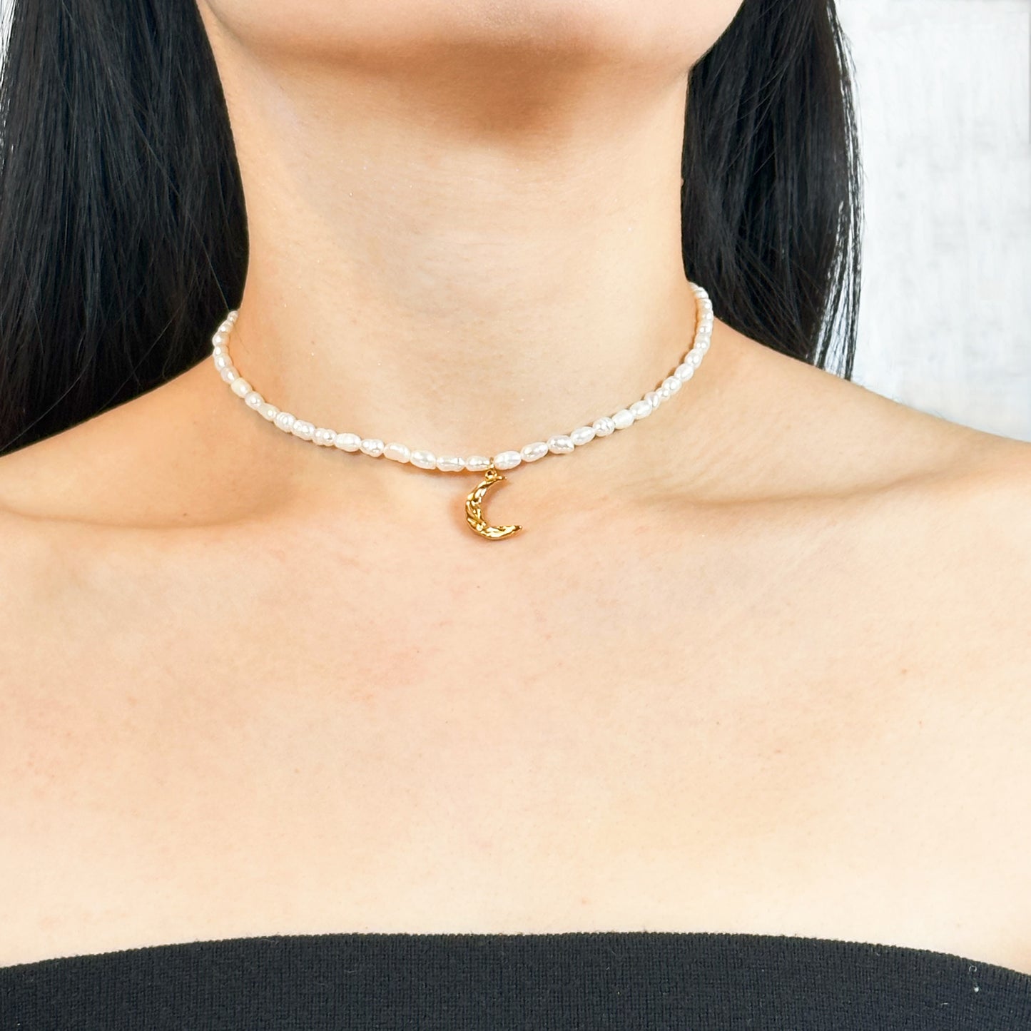 Time-honored freshwater pearl necklace with a unique 18k gold plated crescent moon charm.