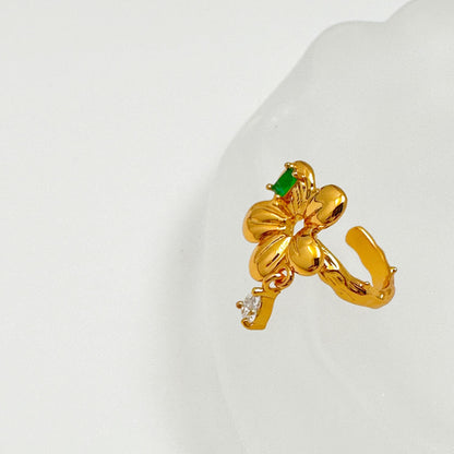 Elegant ear cuff with 18k gold plating, showcasing a bright green gemstone and delicate gemstone drop detail.