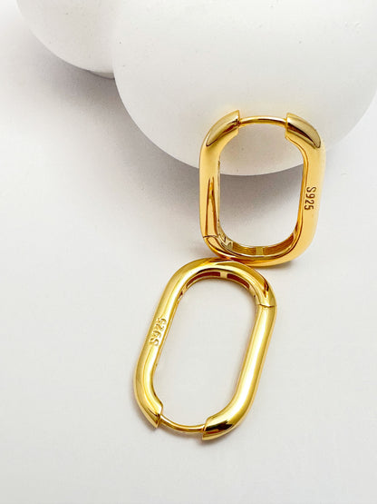 Contemporary s925 silver hoop earrings displayed on a white backdrop, highlighting the modern design.