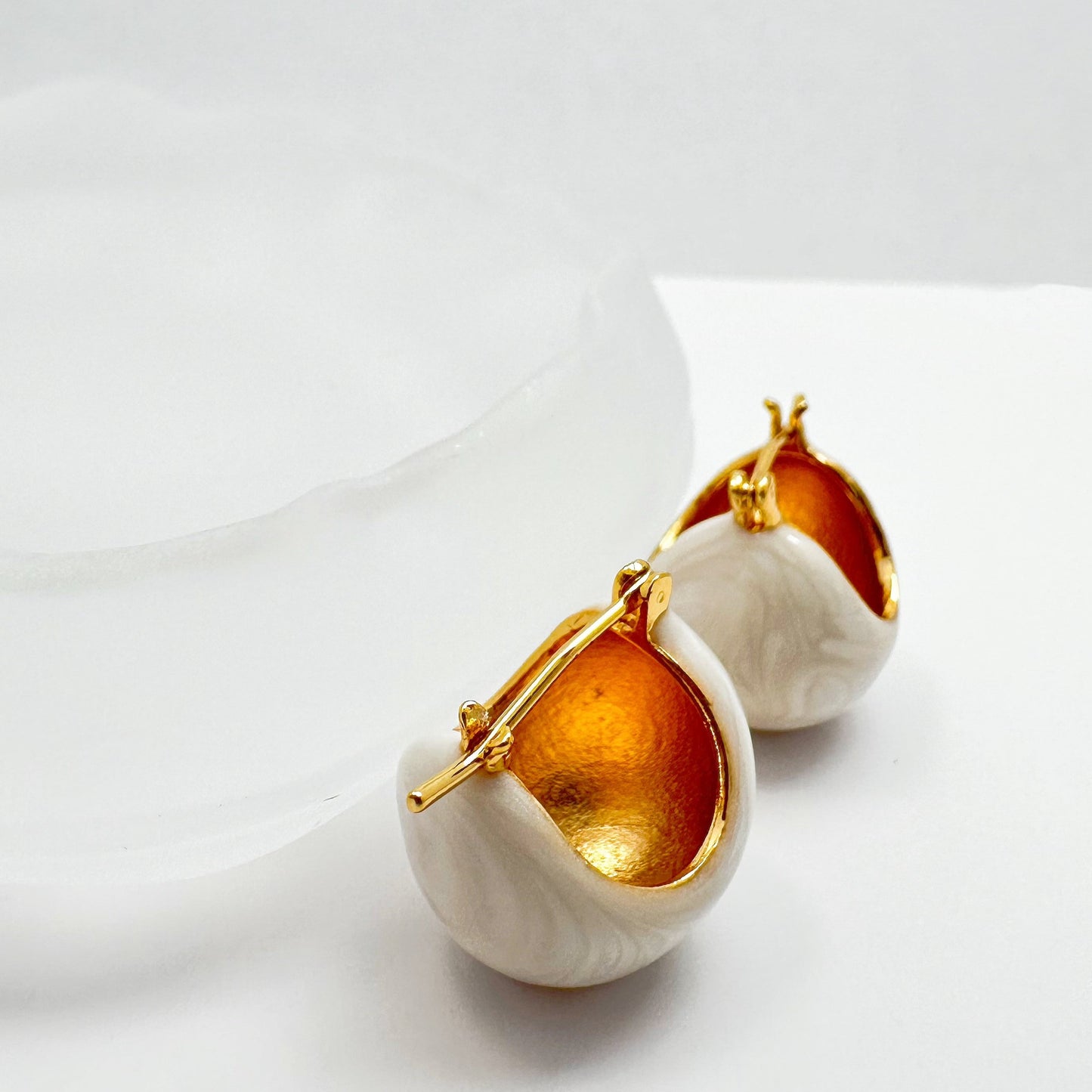 Modern 18k gold-plated earrings with a lustrous white glaze detail