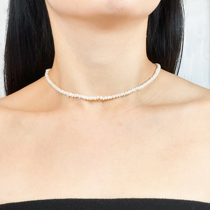 Timeless natural pearl necklace with a distinctive gold-filled ball in the center