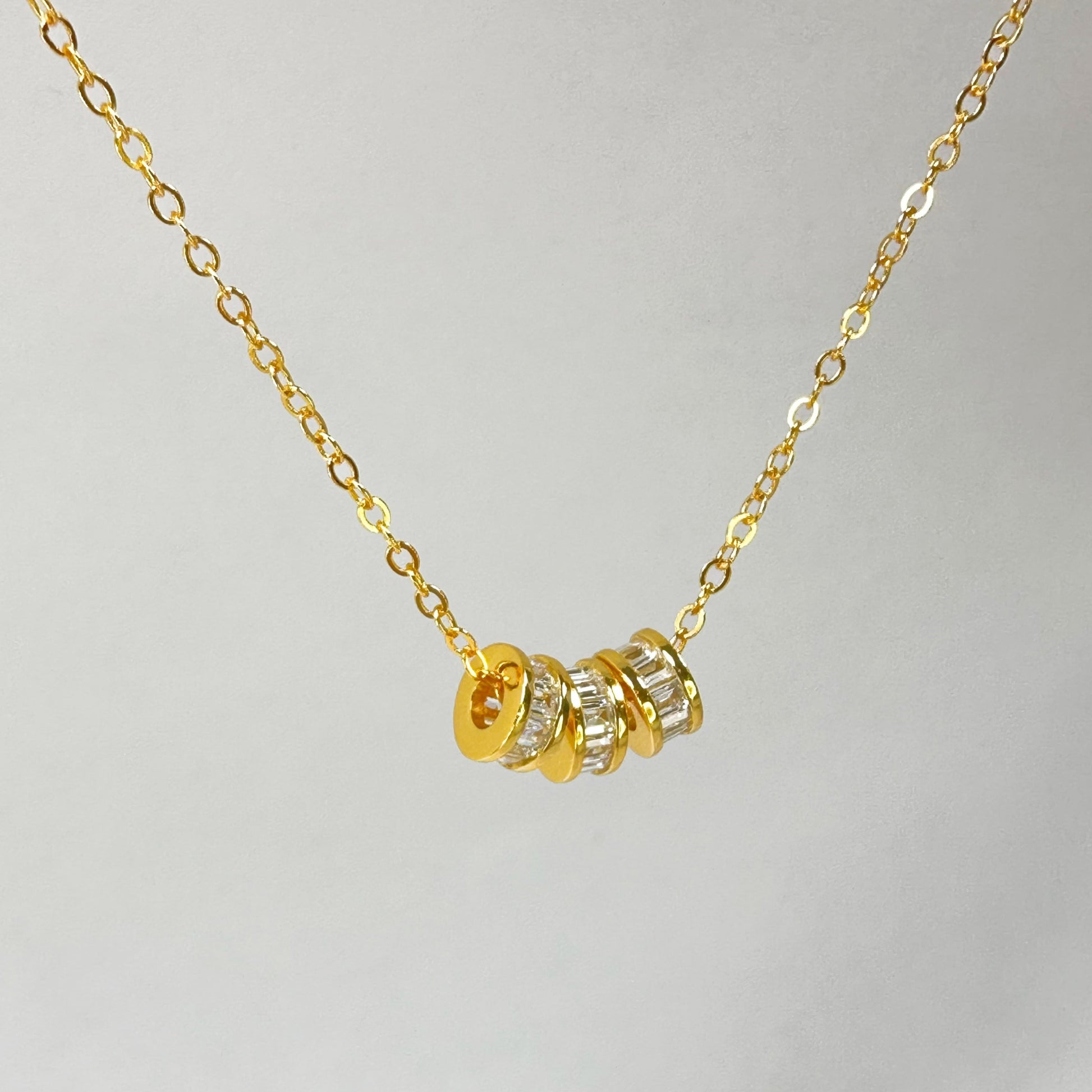 Elegant Lucky Trio Necklace in gold vermeil, featuring three cubic zirconia encrusted charms on a delicate chain, showcasing a sparkling, sophisticated design