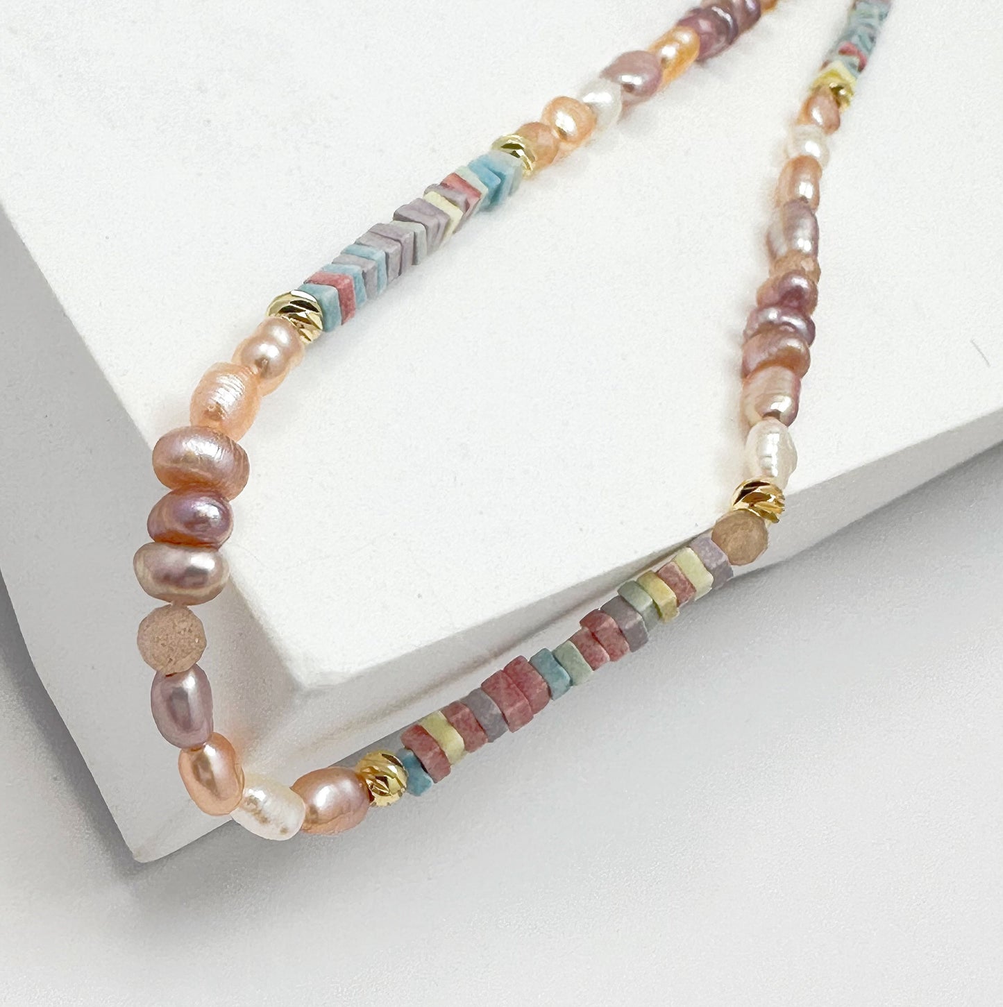 Artisan-crafted gold-filled necklace with an array of natural pearls and delicate crystals