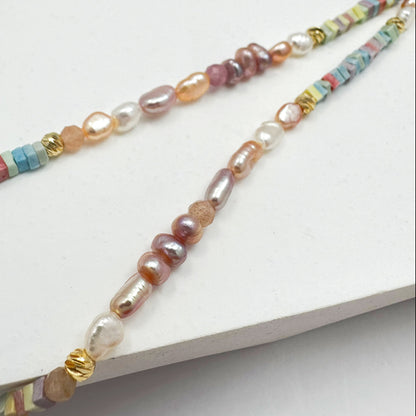 Artisan-crafted gold-filled necklace with an array of natural pearls and delicate crystals