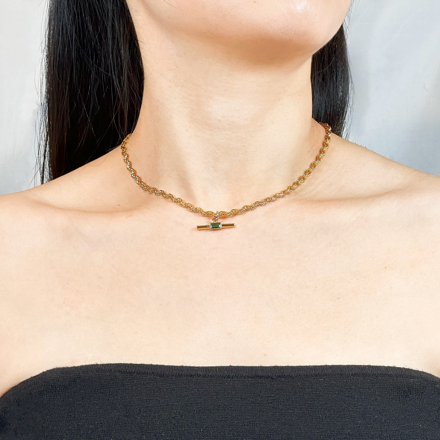 Elegant necklace with a gold-plated twisted chain and a rectangular green zircon pendant.