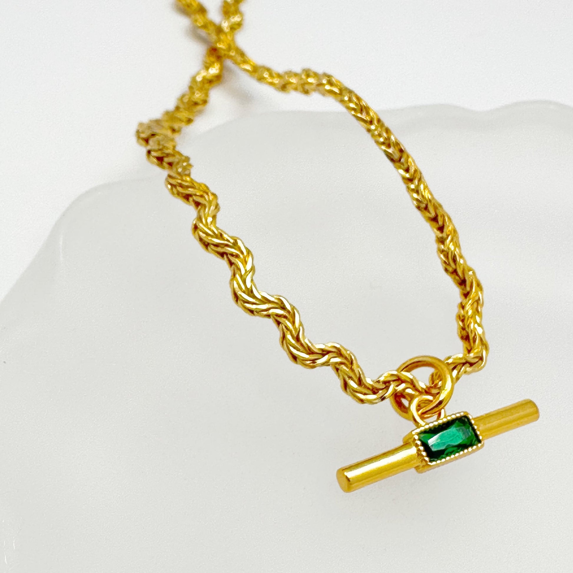 Elegant necklace with a gold-plated twisted chain and a rectangular green zircon pendant.