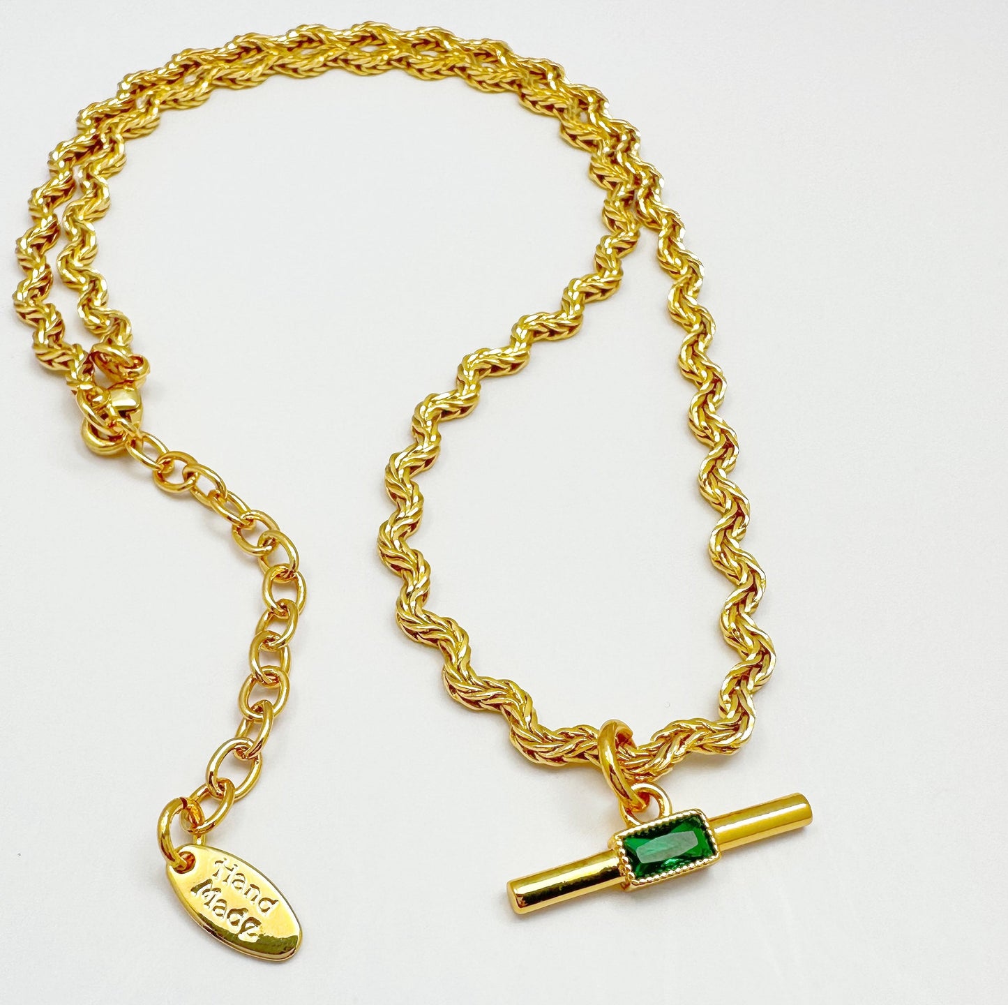 Elegant necklace with a gold-plated twisted chain and a rectangular green zircon pendant.