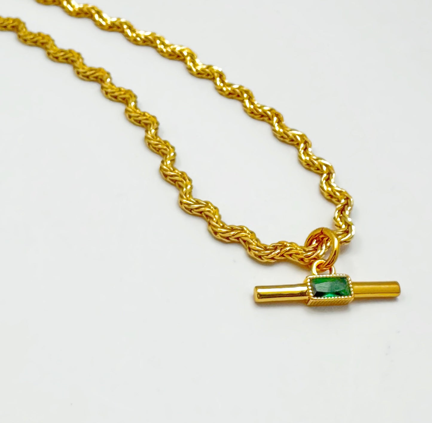 Elegant necklace with a gold-plated twisted chain and a rectangular green zircon pendant.