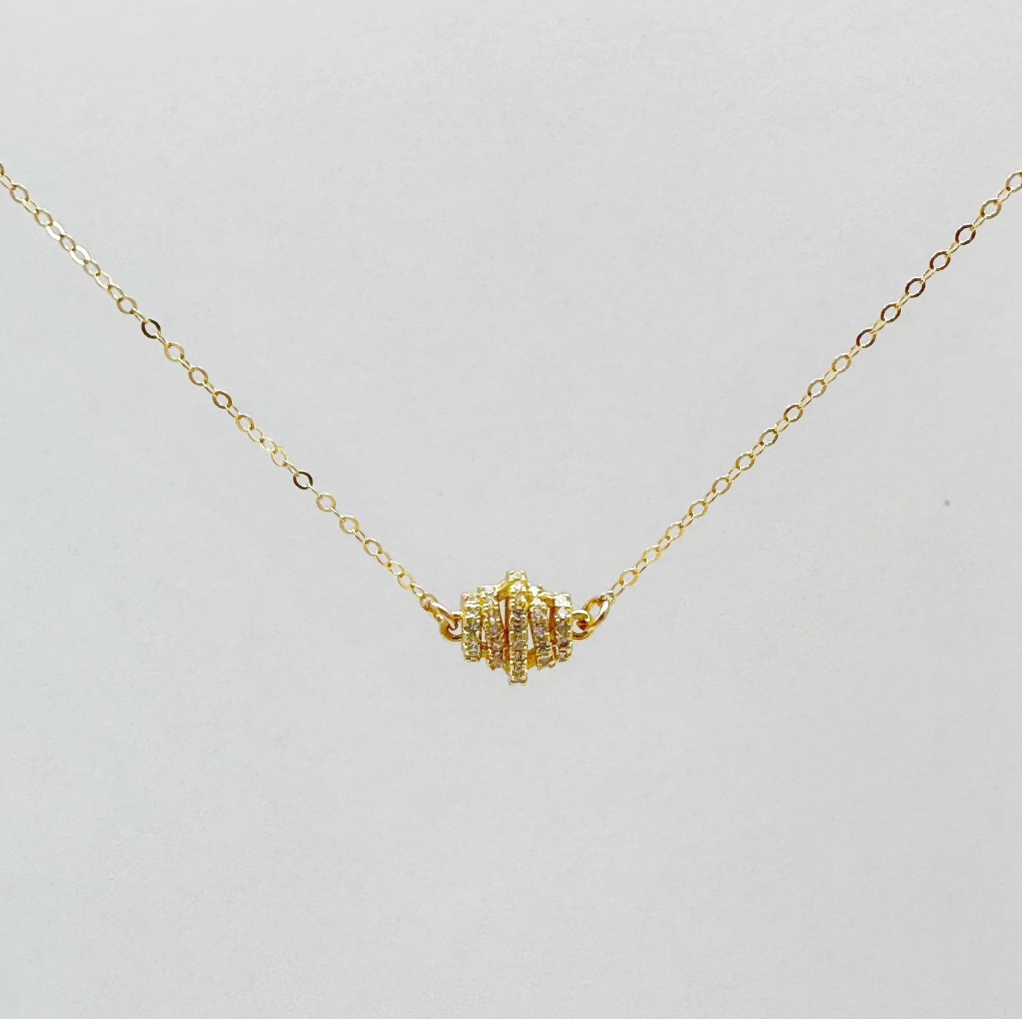 Gold-filled chain necklace with a zircon-studded pendant in a classic design