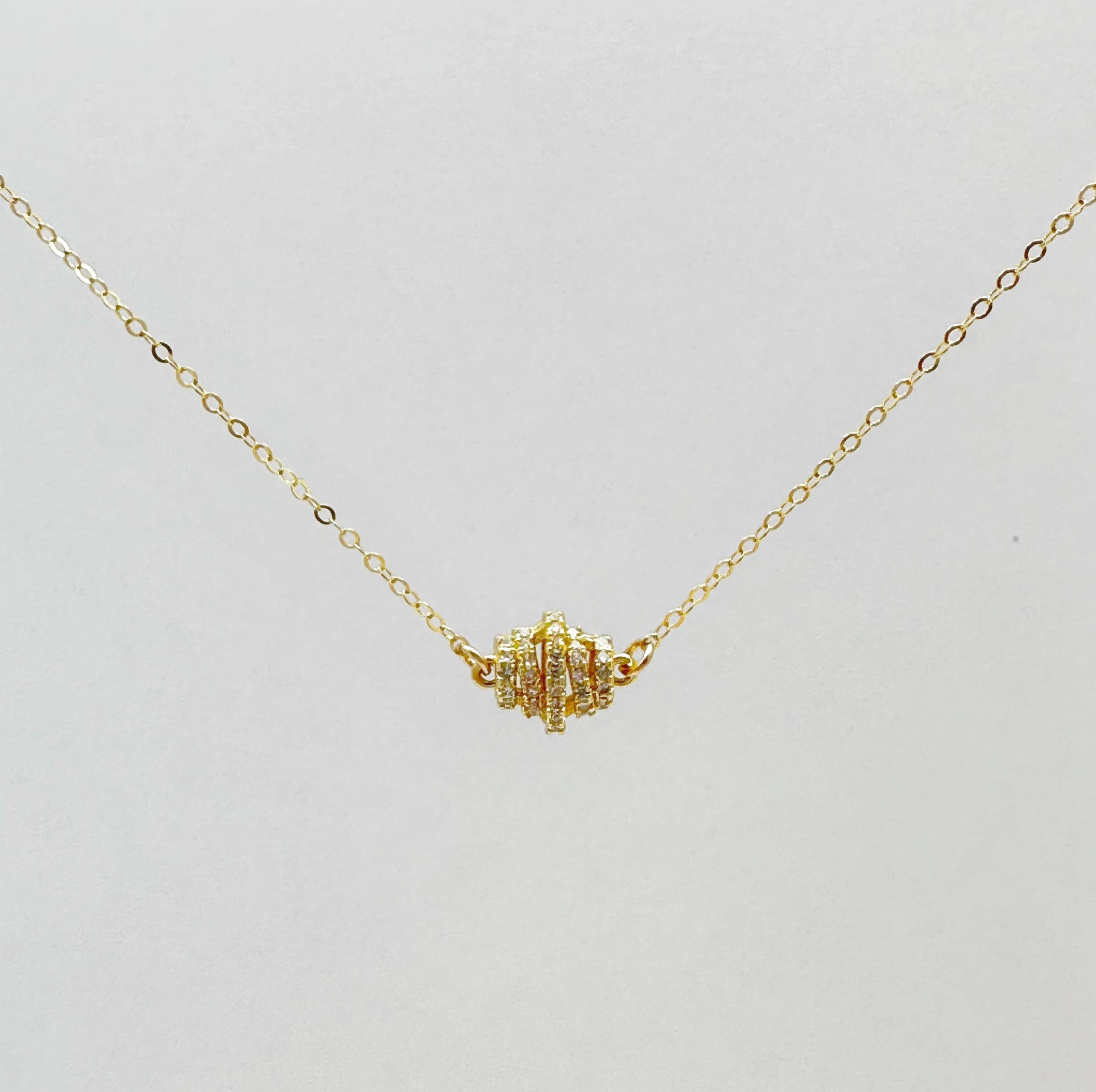 Gold-filled chain necklace with a zircon-studded pendant in a classic design