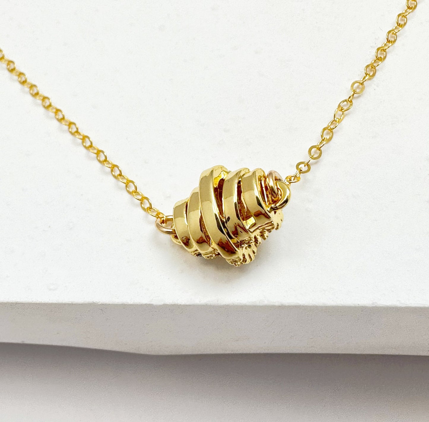 Gold-filled chain necklace with a zircon-studded pendant in a classic design