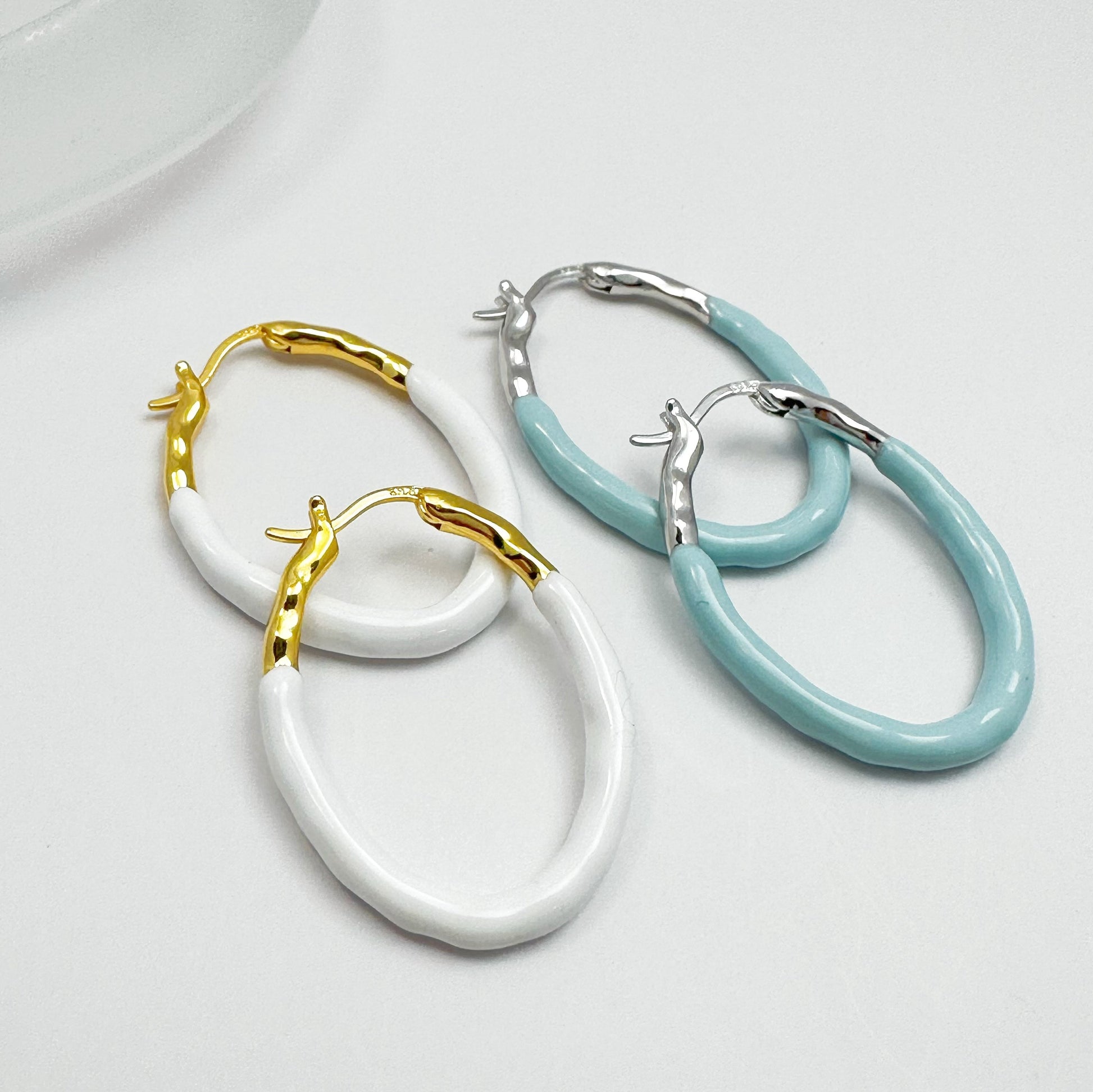 Gold Vermeil hoop earrings with a pastel blue dripping glaze finish.