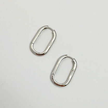 Contemporary s925 silver hoop earrings displayed on a white backdrop, highlighting the modern design.