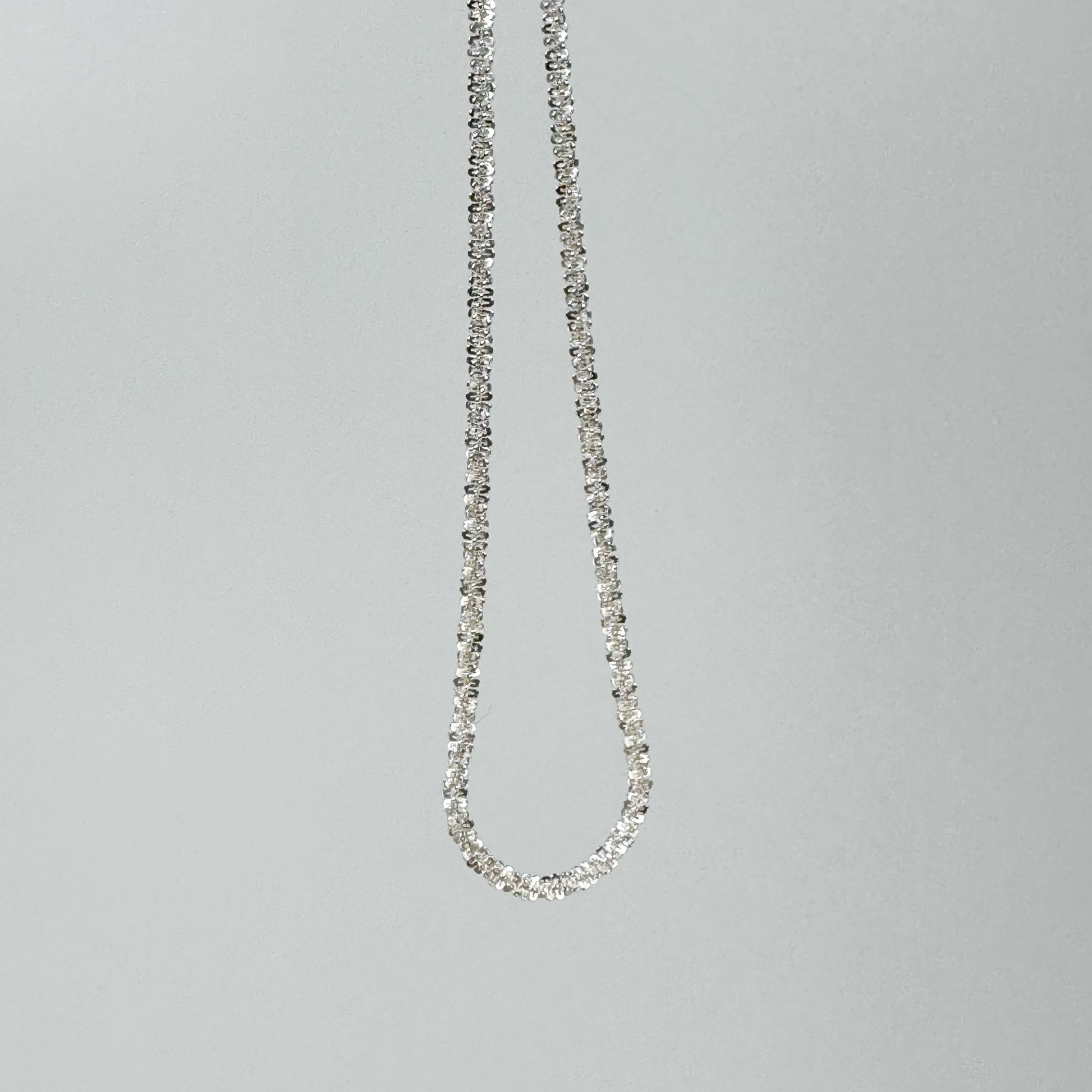 Sparkling S925 sterling silver necklace displayed on a neutral backdrop, showcasing a classic and elegant design