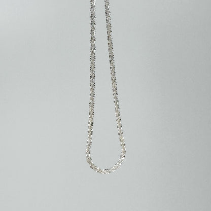 Sparkling S925 sterling silver necklace displayed on a neutral backdrop, showcasing a classic and elegant design