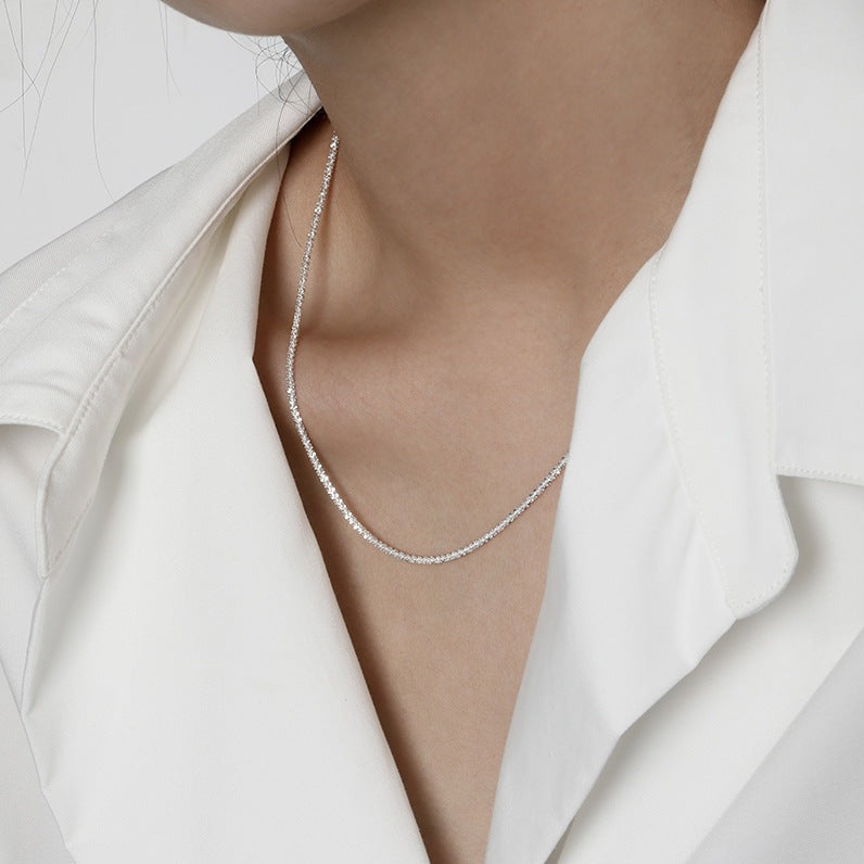 Sparkling S925 sterling silver necklace displayed on a neutral backdrop, showcasing a classic and elegant design