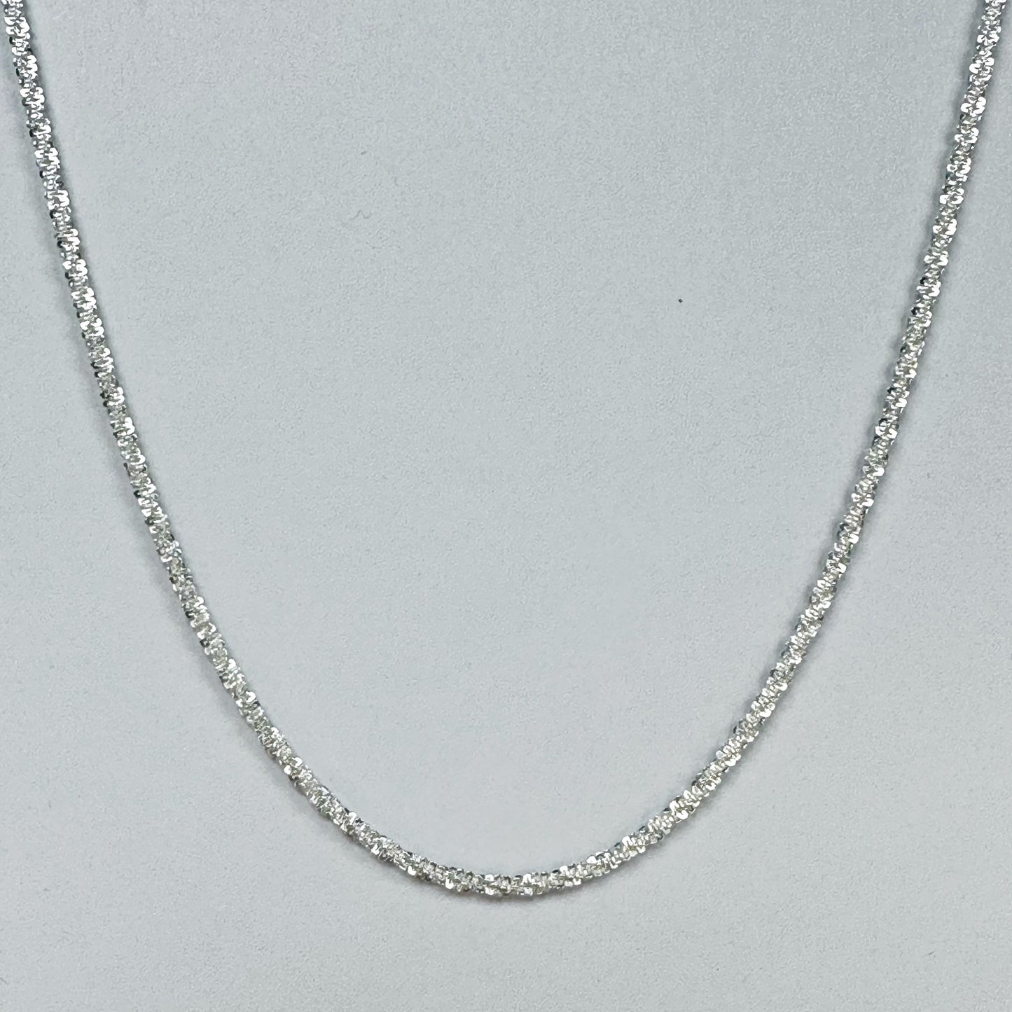 Sparkling S925 sterling silver necklace displayed on a neutral backdrop, showcasing a classic and elegant design