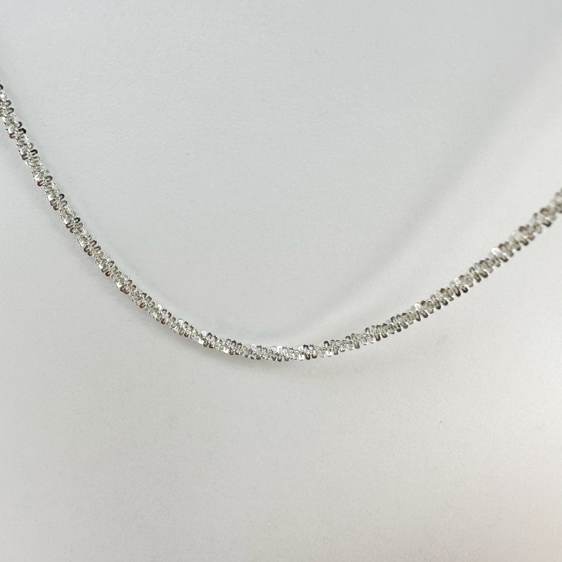 Sparkling S925 sterling silver necklace displayed on a neutral backdrop, showcasing a classic and elegant design