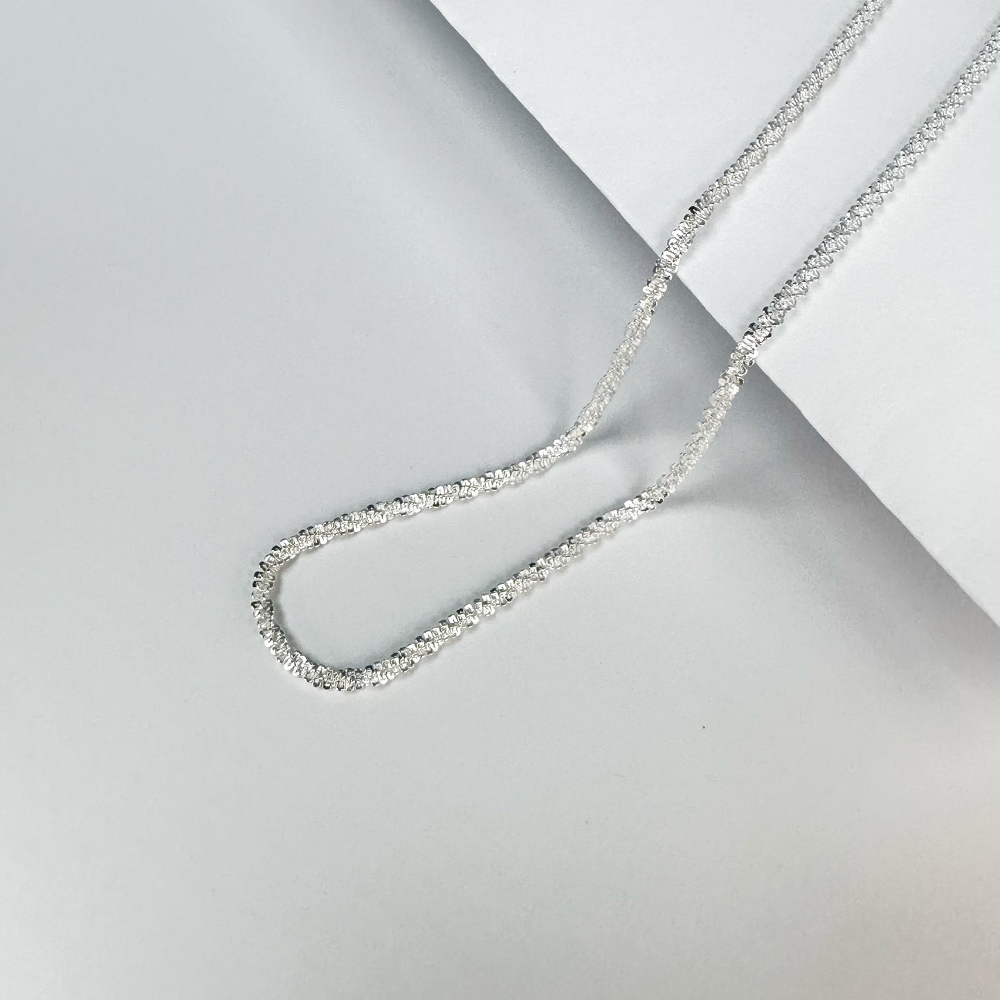 Sparkling S925 sterling silver necklace displayed on a neutral backdrop, showcasing a classic and elegant design